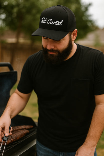 Texas BBQ pitmaster wearing black Rib Cartel Hat from CLC Apparel.