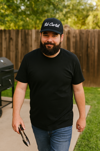 Texas BBQ pitmaster wearing black Rib Cartel Hat from CLC Apparel.